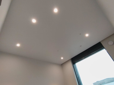 Белый-матовый натяжной потолок на алюминиевом профиле с трек-системами, скрытым карнизом и встраиваемыми и накладными светильниками 